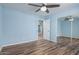 Light blue bedroom with wood-look floors and mirrored closet at 8549 W El Caminito Dr, Peoria, AZ 85345