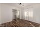 Bright bedroom featuring wood-look floors, large windows, and a mirrored closet for ample storage at 8549 W El Caminito Dr, Peoria, AZ 85345