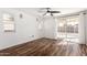 Bright bedroom featuring wood floors, a ceiling fan, and sliding glass doors at 8549 W El Caminito Dr, Peoria, AZ 85345