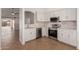 Modern kitchen with stainless steel appliances and white cabinets at 8549 W El Caminito Dr, Peoria, AZ 85345