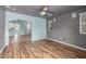 Living room with wood-look tile floors and view into adjacent room at 8549 W El Caminito Dr, Peoria, AZ 85345