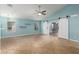 Bright living room with vaulted ceiling, tile floors, and barn doors at 8549 W El Caminito Dr, Peoria, AZ 85345