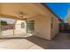 A covered patio with a ceiling fan and sliding glass doors at 8549 W El Caminito Dr, Peoria, AZ 85345