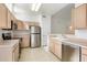 A kitchen featuring stainless steel appliances, tile floor, and light colored wood cabinets at 11260 N 92Nd St # 1080, Scottsdale, AZ 85260