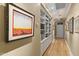 Hallway with hardwood floors, built-in shelves, and art at 14 E 14Th St, Tempe, AZ 85281