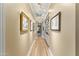 Long hallway with hardwood floors, built-in shelves, and art at 14 E 14Th St, Tempe, AZ 85281