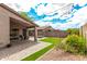 Covered patio, stone fire pit, and manicured landscaping create an inviting outdoor entertainment space at 15912 W Marconi Ave, Surprise, AZ 85374