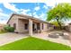 Home's exterior highlights a covered patio, fire pit, desert landscaping, and a cozy outdoor living area at 15912 W Marconi Ave, Surprise, AZ 85374