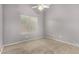 A cozy bedroom features carpet, a window, and ceiling fan at 15912 W Marconi Ave, Surprise, AZ 85374