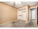 A carpeted bedroom has a window, closet and hall access at 15912 W Marconi Ave, Surprise, AZ 85374