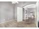 A bedroom leads to a hallway with a fireplace and wood flooring at 15912 W Marconi Ave, Surprise, AZ 85374