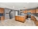 Spacious kitchen with stainless steel appliances, tile floors and kitchen island at 15912 W Marconi Ave, Surprise, AZ 85374