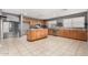 Well-equipped kitchen featuring stainless steel appliances, ample counter space, and tile floors at 15912 W Marconi Ave, Surprise, AZ 85374