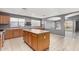 Bright kitchen with stainless steel appliances, oak cabinets, and tile flooring at 15912 W Marconi Ave, Surprise, AZ 85374