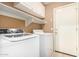 A laundry room features a modern washer/dryer and shelving at 15912 W Marconi Ave, Surprise, AZ 85374