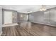 Inviting living room with hardwood floors, neutral paint, and lots of natural light at 15912 W Marconi Ave, Surprise, AZ 85374
