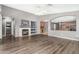 Open living room with a fireplace, built in shelving, and hardwood floors at 15912 W Marconi Ave, Surprise, AZ 85374