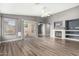Bright living room with sliding glass doors, fireplace, and hardwood floors at 15912 W Marconi Ave, Surprise, AZ 85374
