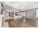 Open living room and kitchen area featuring hardwood floors and lots of natural light at 15912 W Marconi Ave, Surprise, AZ 85374