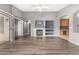 Spacious living room featuring a fireplace, shelving, and hardwood floors at 15912 W Marconi Ave, Surprise, AZ 85374