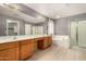 Main bathroom with double sinks, soaking tub, and glass enclosed shower at 15912 W Marconi Ave, Surprise, AZ 85374