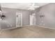 Open main bedroom with carpeted floors, ceiling fan, and access to the main bathroom at 15912 W Marconi Ave, Surprise, AZ 85374