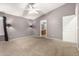 Comfortable main bedroom featuring carpeted floors, a fan, and a closet at 15912 W Marconi Ave, Surprise, AZ 85374