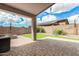 Covered patio with stone flooring, fire pit, and backyard view at 15912 W Marconi Ave, Surprise, AZ 85374