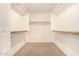 Walk-in closet with neutral paint, carpet flooring, and shelving units at 15912 W Marconi Ave, Surprise, AZ 85374