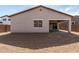 The backyard features a blank canvas of dirt, an extended patio, and a block wall at 17586 W Blue Sky Dr, Surprise, AZ 85387