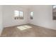 Sunlit bedroom showcasing wood-style flooring and large windows at 17586 W Blue Sky Dr, Surprise, AZ 85387