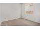 Small, bright bedroom featuring neutral carpet and a window at 17586 W Blue Sky Dr, Surprise, AZ 85387