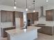 Modern kitchen with island, stainless steel appliances, and subway tile backsplash at 17586 W Blue Sky Dr, Surprise, AZ 85387