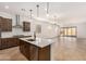 Bright, modern kitchen featuring a center island, sleek stainless-steel appliances, and an open floor plan at 17586 W Blue Sky Dr, Surprise, AZ 85387