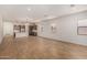 Open-concept living area with wood-look tile floors, recessed lighting, and large windows at 17586 W Blue Sky Dr, Surprise, AZ 85387