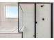 Contemporary bathroom with walk-in shower, bench, and black hardware at 17586 W Blue Sky Dr, Surprise, AZ 85387