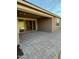 Covered patio with paver flooring and sliding glass doors leading to the interior of the home at 17826 W Straight Arrow Ln, Surprise, AZ 85387