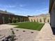 An expansive backyard features a manicured lawn, desert landscaping, and a paved patio for outdoor living at 21627 W Mariposa St, Buckeye, AZ 85396