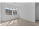 Sunlit bedroom with large windows, neutral paint, and tile flooring for a clean, contemporary look at 21627 W Mariposa St, Buckeye, AZ 85396