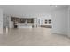 Open floor plan with a kitchen featuring dark wood cabinets and a large center island at 21627 W Mariposa St, Buckeye, AZ 85396
