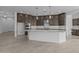 Kitchen showcasing a central island with marble countertops and stainless steel appliances at 21627 W Mariposa St, Buckeye, AZ 85396