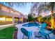 Inviting backyard oasis with a sparkling pool, lush landscaping, and relaxing patio furniture at 23914 N 25Th Way, Phoenix, AZ 85024