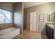 Elegant Primary bathroom with a soaking tub, walk-in shower, and double vanity at 23914 N 25Th Way, Phoenix, AZ 85024