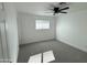 Simple bedroom with neutral walls, ceiling fan, and gray carpeting at 3733 W El Caminito Dr, Phoenix, AZ 85051