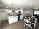 Open concept kitchen and dining area with modern island and stylish decor at 3733 W El Caminito Dr, Phoenix, AZ 85051