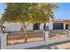 Remodeled home with a white brick facade, black garage door, and a landscaped front yard at 4315 E Nancy Ln, Phoenix, AZ 85042