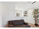 Cozy living room featuring a brown couch and a kitchen pass-through at 4315 E Nancy Ln, Phoenix, AZ 85042