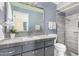 Modern bathroom with gray tile and a walk-in shower at 6255 E Ensenada St, Mesa, AZ 85205