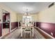 Charming dining room with hardwood floors and a wooden table at 6255 E Ensenada St, Mesa, AZ 85205