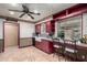 Bright kitchen with red cabinets, a farmhouse sink, and ample counter space at 6255 E Ensenada St, Mesa, AZ 85205